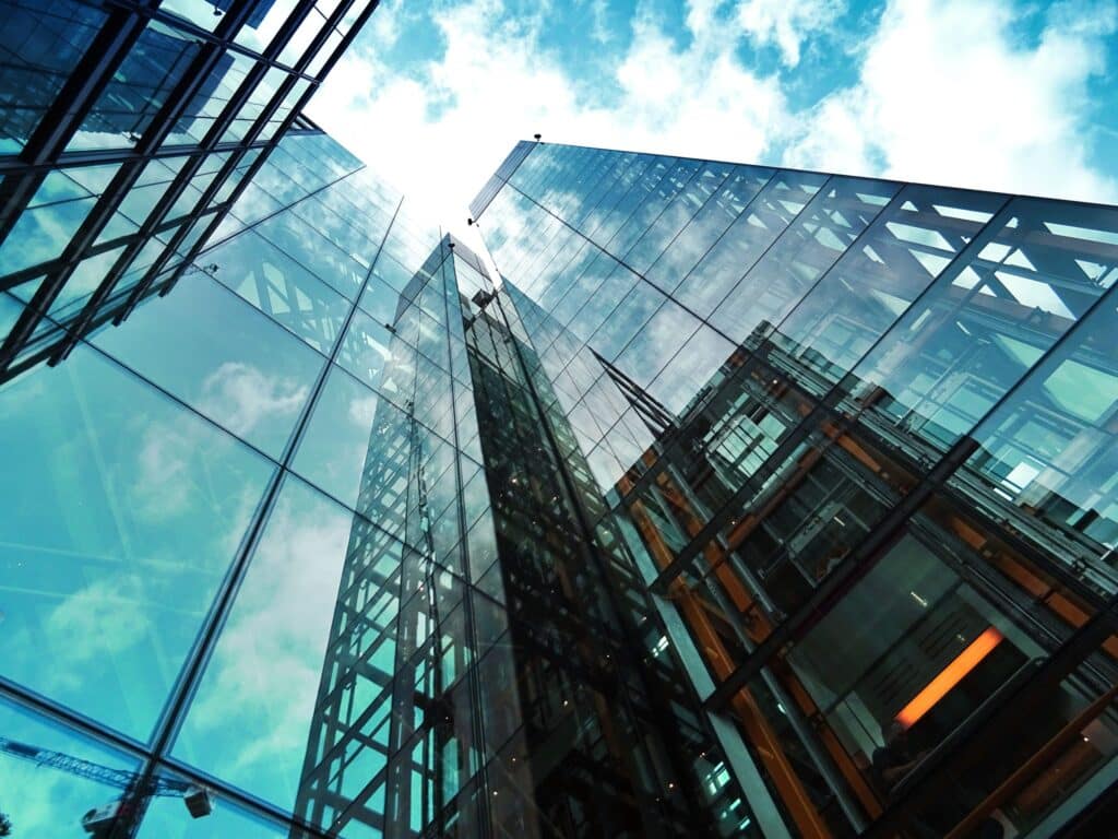 Modern glass skyscrapers under a blue sky