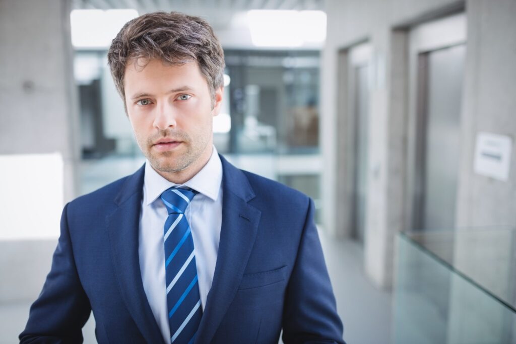 Man in a blue suit in a modern office